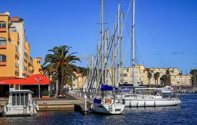 a group of boats docked in a harbor with buildings at 2 Bedroom Lovely Home In Saint-Laurent-De-La-Ca in Saint-Laurent-de-la-Cabrerisse