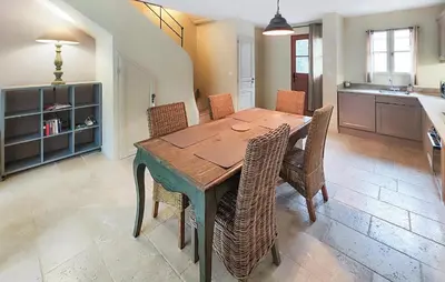 a dining room with a wooden table and chairs at 2 Bedroom Lovely Home In Saint-Laurent-De-La-Ca in Saint-Laurent-de-la-Cabrerisse