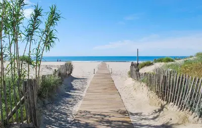 a wooden path through the sand to the beach at 2 Bedroom Lovely Home In Saint-Laurent-De-La-Ca in Saint-Laurent-de-la-Cabrerisse