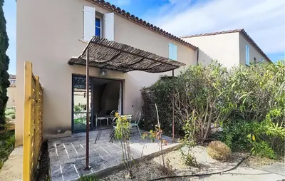 a villa with a patio in front of a house at 1 Bedroom Amazing Home In Saint-Laurent-De-La-Ca in Saint-Laurent-de-la-Cabrerisse