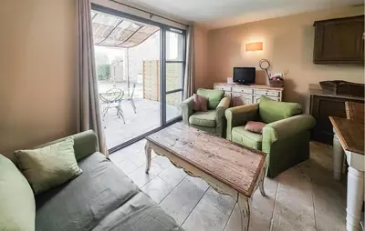 a living room with a couch and chairs and a table at 1 Bedroom Amazing Home In Saint-Laurent-De-La-Ca in Saint-Laurent-de-la-Cabrerisse