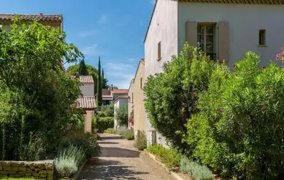 an alley in a village with trees and a building at 1 Bedroom Amazing Home In Saint-Laurent-De-La-Ca in Saint-Laurent-de-la-Cabrerisse