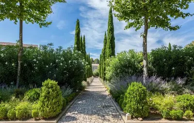a path in a garden with trees and bushes at 1 Bedroom Amazing Home In Saint-Laurent-De-La-Ca in Saint-Laurent-de-la-Cabrerisse