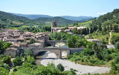a bridge over a river in a small village at 1 Bedroom Amazing Home In Saint-Laurent-De-La-Ca in Saint-Laurent-de-la-Cabrerisse