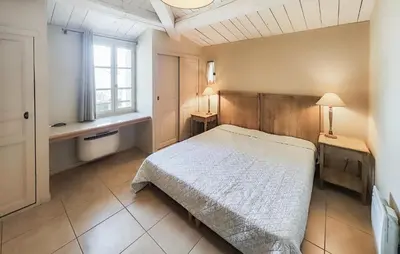 a bedroom with a large bed and a window at 1 Bedroom Amazing Home In Saint-Laurent-De-La-Ca in Saint-Laurent-de-la-Cabrerisse