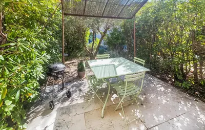 a picnic table and a grill on a patio at 2 Bedroom Cozy Home In Saint-Laurent-De-La-Ca in Saint-Laurent-de-la-Cabrerisse