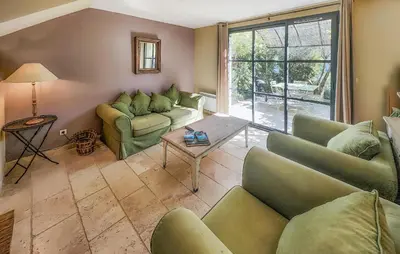 a living room with two couches and a table at 2 Bedroom Cozy Home In Saint-Laurent-De-La-Ca in Saint-Laurent-de-la-Cabrerisse