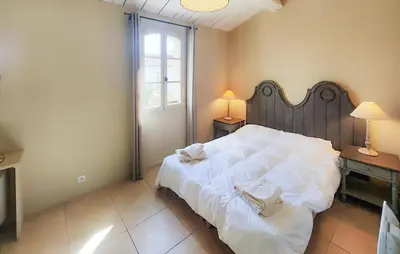 a bedroom with a large white bed and a window at 2 Bedroom Cozy Home In Saint-Laurent-De-La-Ca in Saint-Laurent-de-la-Cabrerisse