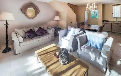 a living room with two couches and a table at 2 Bedroom Awesome Home In Saint-Laurent-De-La-Ca in Saint-Laurent-de-la-Cabrerisse