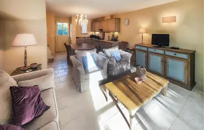 a living room with a couch and a table at 2 Bedroom Awesome Home In Saint-Laurent-De-La-Ca in Saint-Laurent-de-la-Cabrerisse