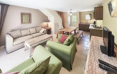 a living room with a couch and a table at 2 Bedroom Gorgeous Home In Saint-Laurent-De-La-Ca in Saint-Laurent-de-la-Cabrerisse