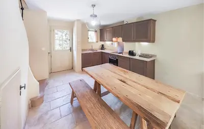 a kitchen with a wooden table in a room at 2 Bedroom Gorgeous Home In Saint-Laurent-De-La-Ca in Saint-Laurent-de-la-Cabrerisse