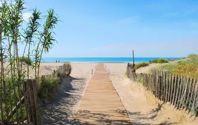 a wooden path to the beach with the ocean in the background at 2 Bedroom Gorgeous Home In Saint-Laurent-De-La-Ca in Saint-Laurent-de-la-Cabrerisse