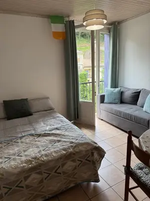 a bedroom with a bed and a couch at Rennes-les-Bains Studio at Thermal Baths in Rennes-les-Bains