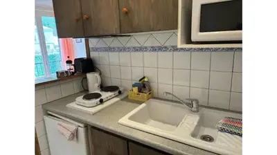 a kitchen counter with a sink and a microwave at Rennes-les-Bains Studio at Thermal Baths in Rennes-les-Bains
