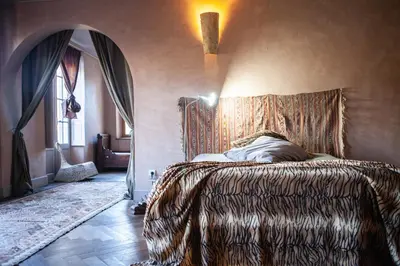 a bedroom with a bed with a patterned head board at Chateau in medieval Bastide - Sleeps up to 10 in Chalabre