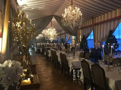 a large banquet hall with white tables and chandeliers at Grands Buffets hébergement Studio Narbonne in Narbonne