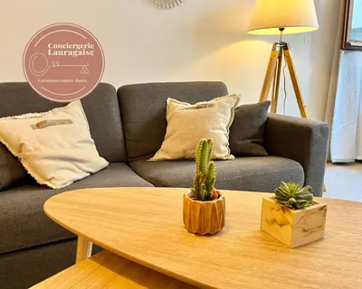 a living room with a couch and a table with a cactus at Studio centre historique RDC - WIFI in Revel