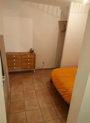 a bedroom with a bed and a dresser in it at Studio centre historique RDC - WIFI in Revel