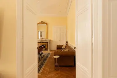 a living room with a couch and a piano at Appartement chic, hôtel particulier, Carcassonne centre in Carcassonne