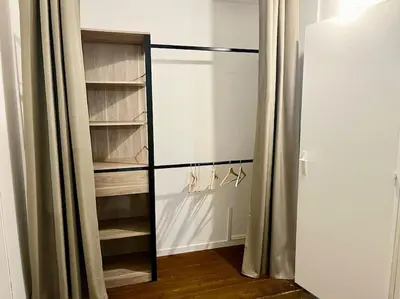a walk in closet with a glass door and shelves at Appartement Victor Hugo - balcon in Revel