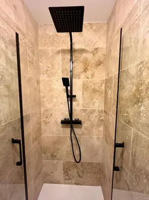 a bathroom with a shower with a glass door at Appartement Victor Hugo - balcon in Revel