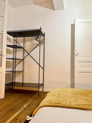 a bedroom with a book shelf and a bed at Appartement Victor Hugo - balcon in Revel