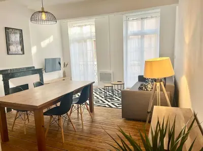 a living room with a table and chairs and a piano at Appartement Victor Hugo - balcon in Revel