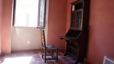 a chair in a room with a desk and a window at River House in medieval bastide - Sleeps up to 6 in Chalabre