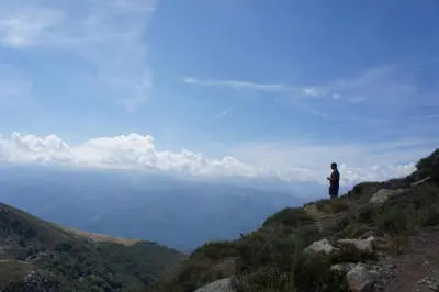 a man standing on top of a mountain overlooking a valley at River House in medieval bastide - Sleeps up to 6 in Chalabre