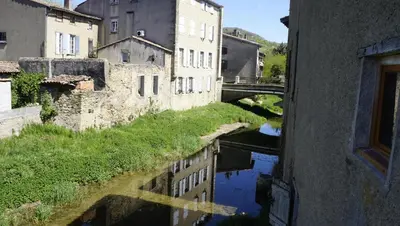 a view of a river with buildings and a bridge at River House in medieval bastide - Sleeps up to 6 in Chalabre