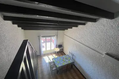 a room with a blue bench and a window at Spacious apartment with lovely terrace in Port-la-Nouvelle