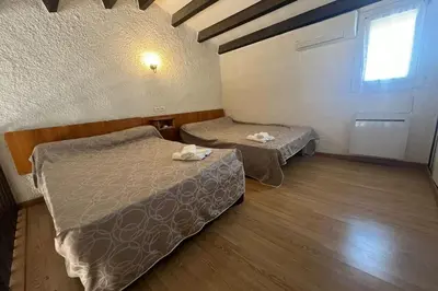 a room with two beds and a window at Spacious apartment with lovely terrace in Port-la-Nouvelle