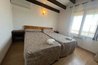 a bedroom with two beds and a window at Spacious apartment with lovely terrace in Port-la-Nouvelle