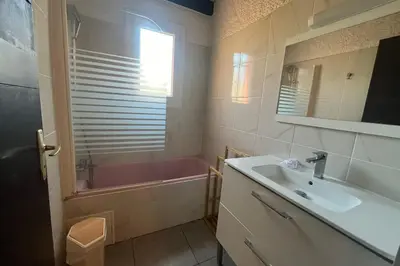 a bathroom with a sink and a bath tub at Spacious apartment with lovely terrace in Port-la-Nouvelle
