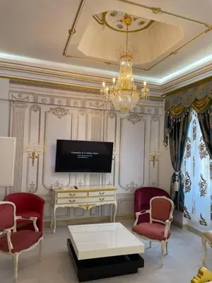 a living room with a tv and a table and chairs at Suite Présidentielle Maison de L'Église in Narbonne