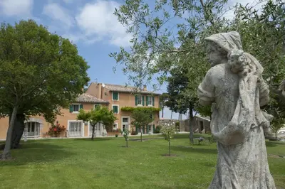 a statue of a woman standing in a park at Château Ciceron in Ribaute