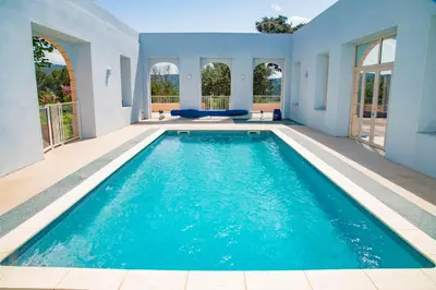 a swimming pool in the middle of a house at Château Ciceron in Ribaute