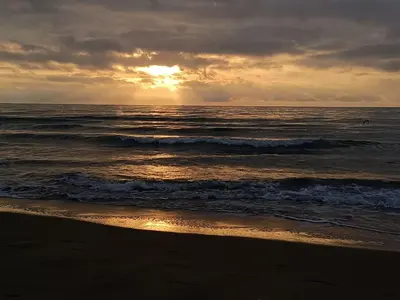 a sunset on the beach with the ocean at Fleur De Sel in Gruissan