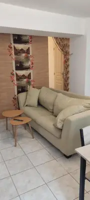 a living room with a couch and two tables at Studio centre ville de Narbonne in Narbonne
