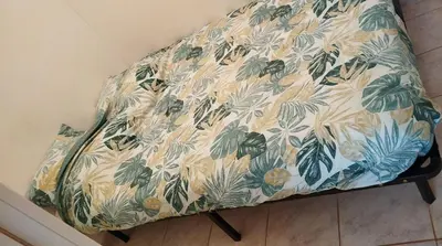 a chair with a floral pattern on it in a room at Studio centre ville de Narbonne in Narbonne