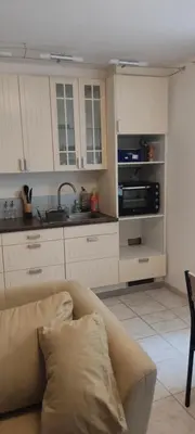a living room with a couch and a kitchen at Studio centre ville de Narbonne in Narbonne