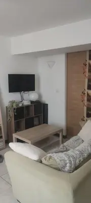 a living room with a tv and a couch at Studio centre ville de Narbonne in Narbonne
