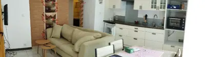 a living room with a couch and a kitchen at Studio centre ville de Narbonne in Narbonne