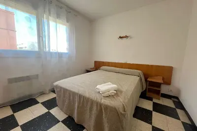 a bedroom with a bed with two towels on it at Charming apartment overlooking the sea in Port-la-Nouvelle