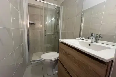 a bathroom with a toilet and a sink and a shower at Charming apartment overlooking the sea in Port-la-Nouvelle