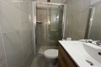 a bathroom with a shower and a toilet and a sink at Charming apartment overlooking the sea in Port-la-Nouvelle