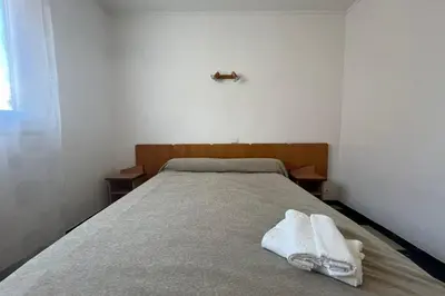 a bedroom with a bed with two towels on it at Charming apartment overlooking the sea in Port-la-Nouvelle