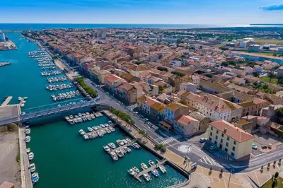 an aerial view of a city with boats in the water at Spacious apartment on the seafront in Port-la-Nouvelle