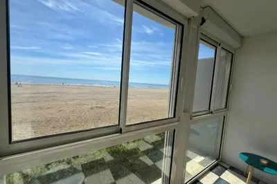 a room with a window looking out at the beach at Spacious apartment on the seafront in Port-la-Nouvelle